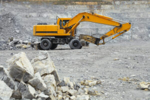 hydraulic hammer on yellow excavator